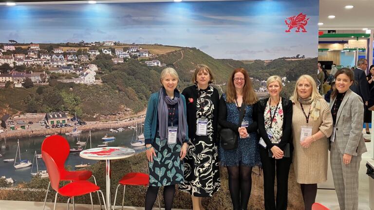 Group of people smiling at the camera at a trade show,