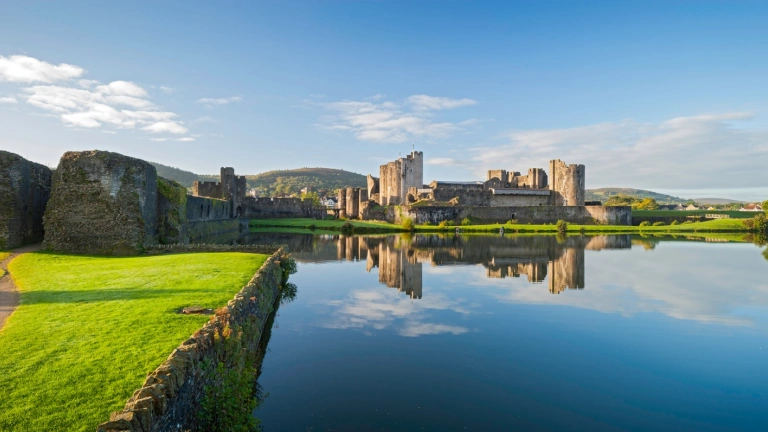Castle overlooking a moat and greenery