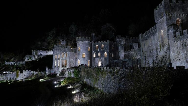 A castle in the spooky glow at nighttime.