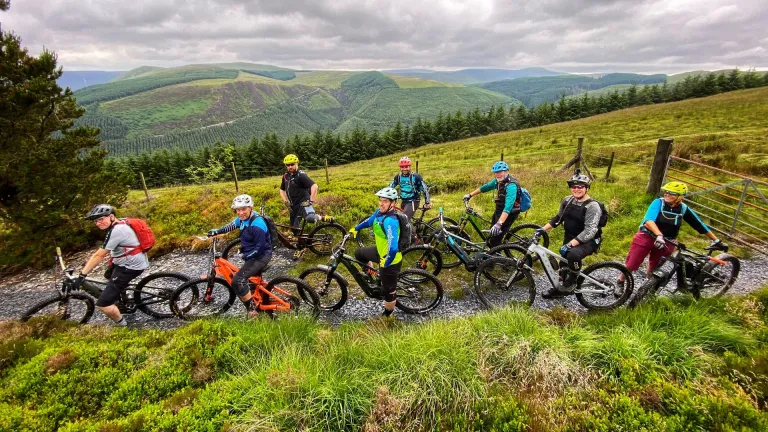 Group of cyclists on eBikes with mountain views beyond