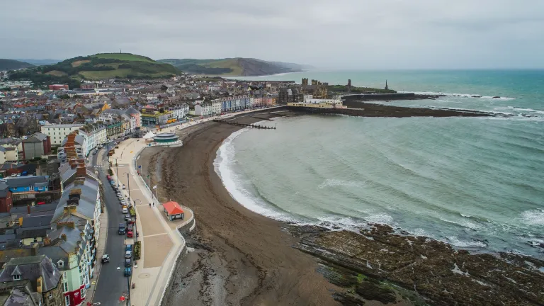 A coastline and town taken from the top of a cliff.