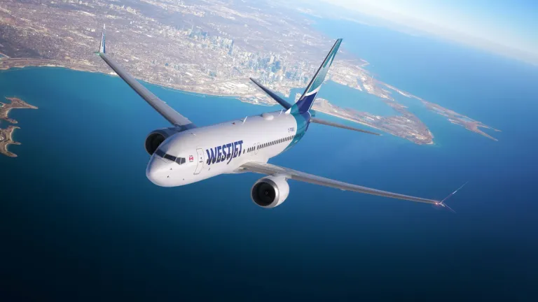 An aircraft in the sky above the sea.