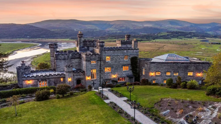Aerial shot of a stately castle accommodation at twilight.