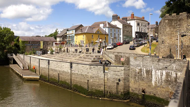 A river with colourful buildings above