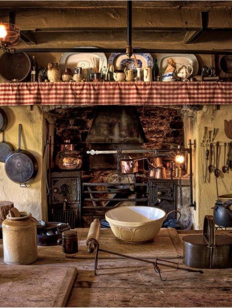 Kitchen dating back to 1870 with pots, pans and utensils hanging around the fire place.