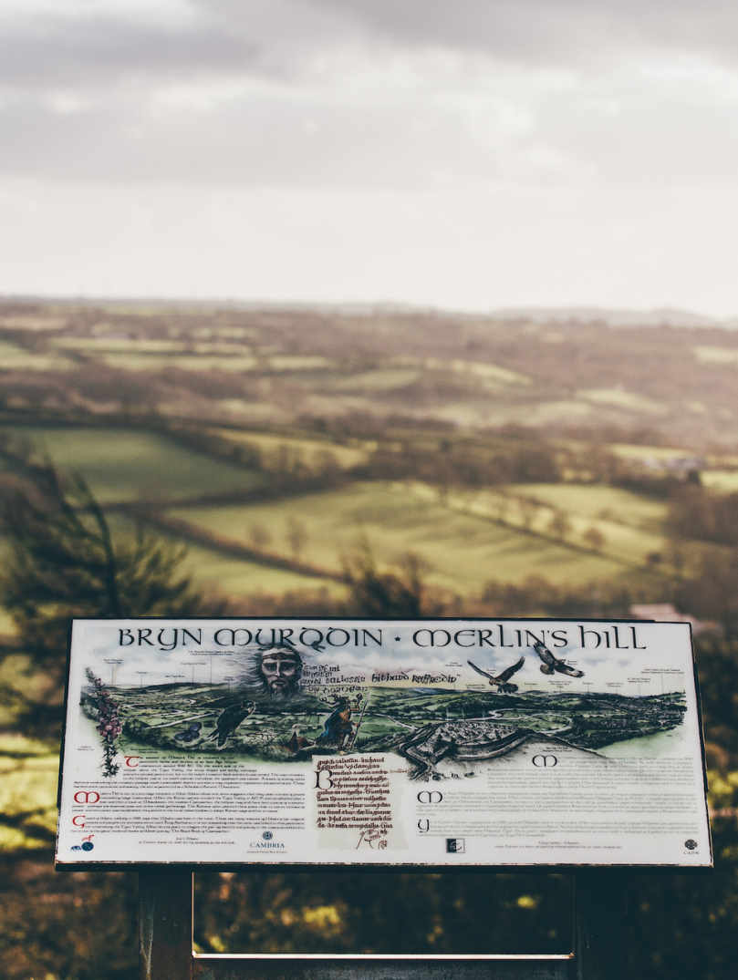A viewpoint of Merlin's Hill with a sign detailing what you can see beyond.