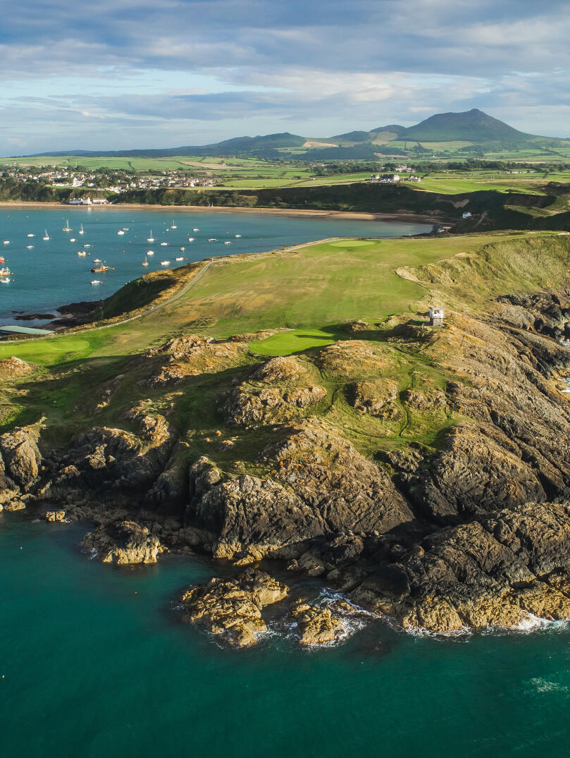 Nefyn golf course surrounded by the sea and mountains.