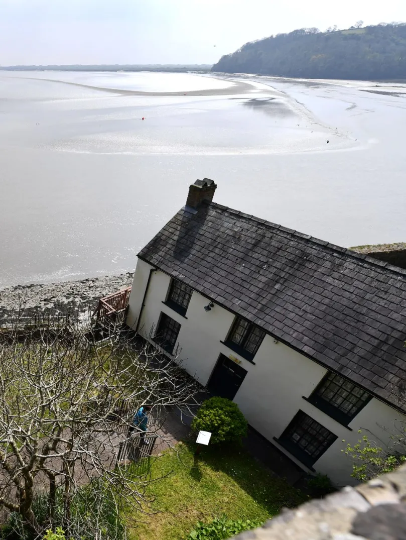 Views of a boathouse and the estuary beyond.