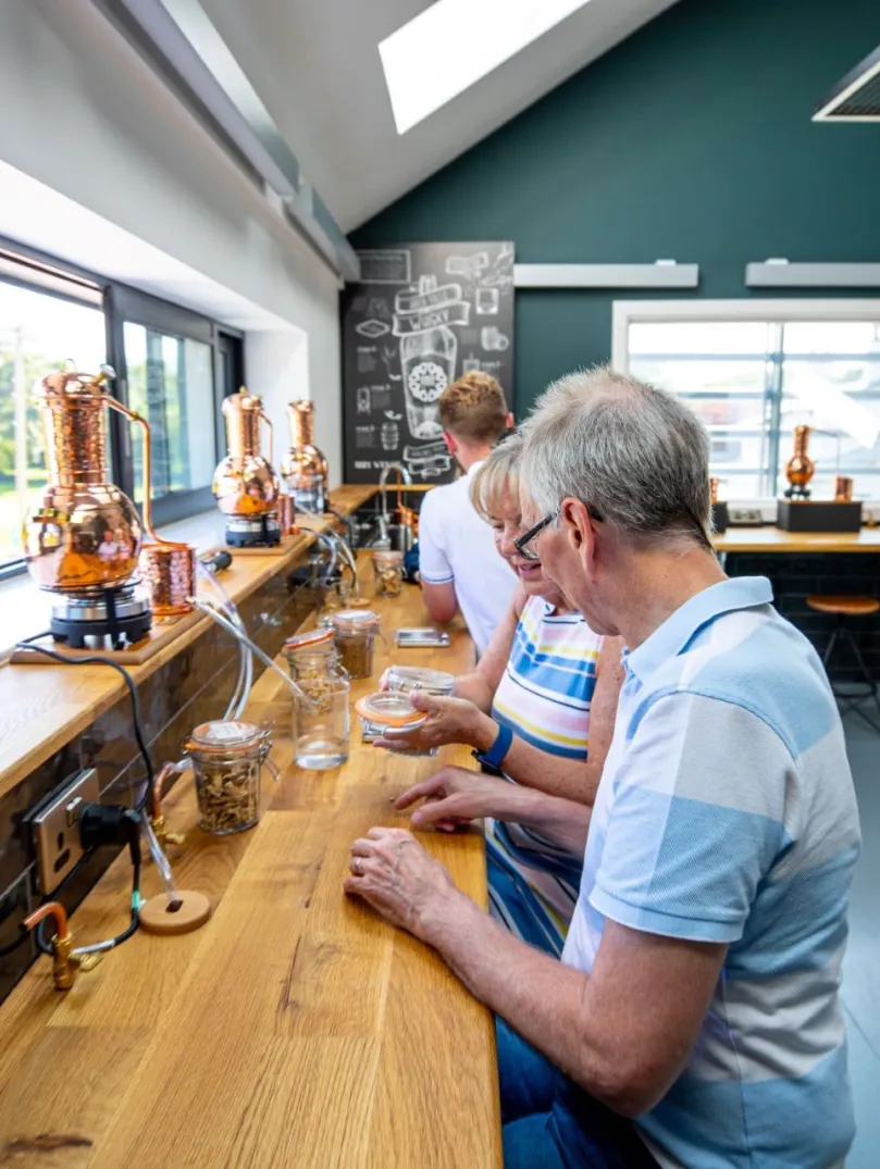 Visitors on a tasting tour at a distillery.
