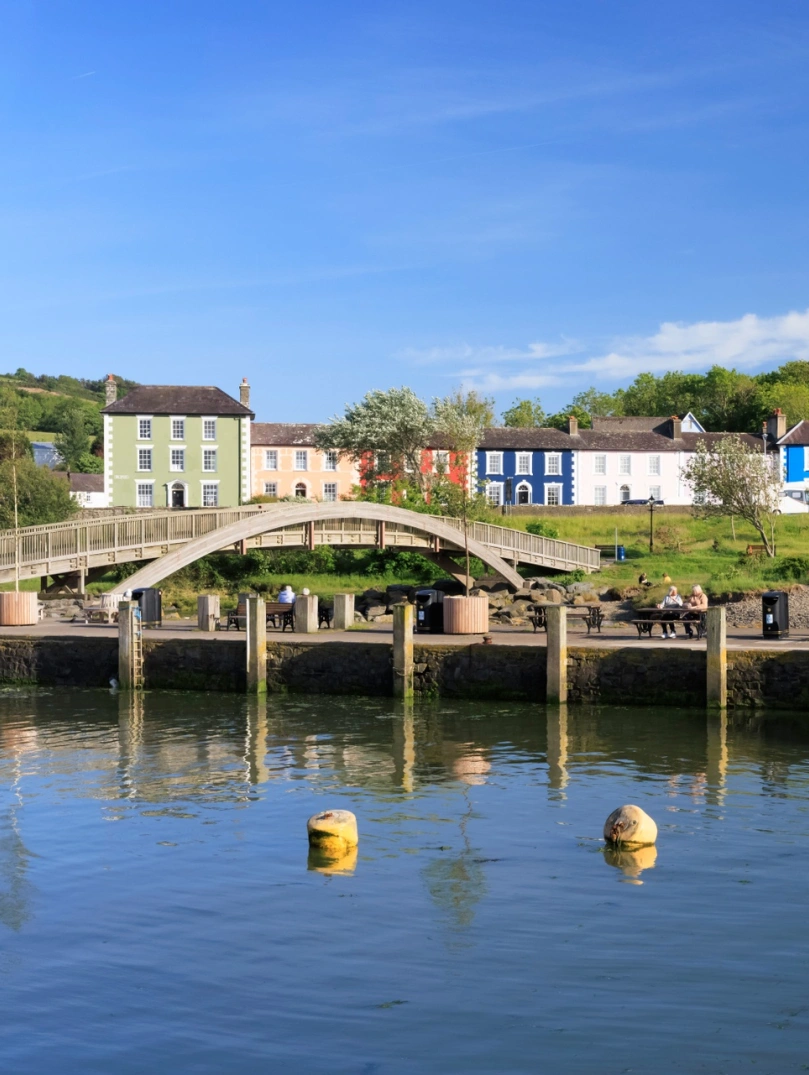 A footbridge going over the estuary in a pretty coastal town.
