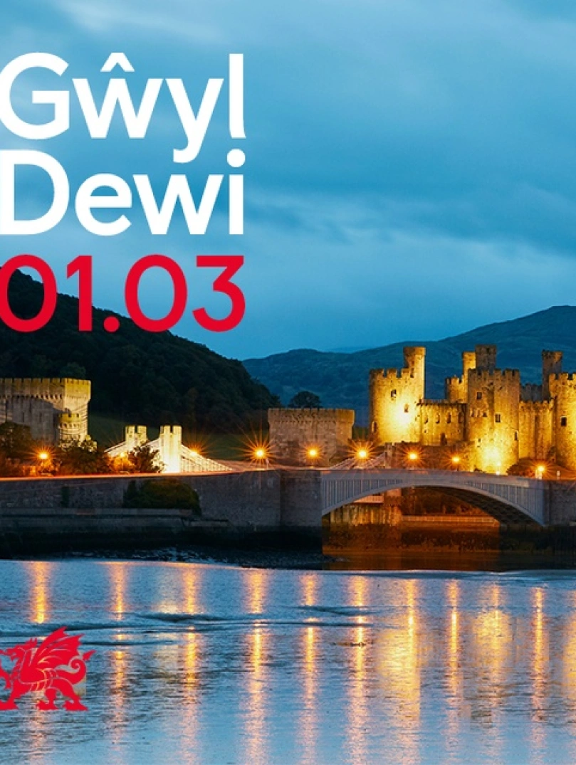 A castle lit up at dusk.