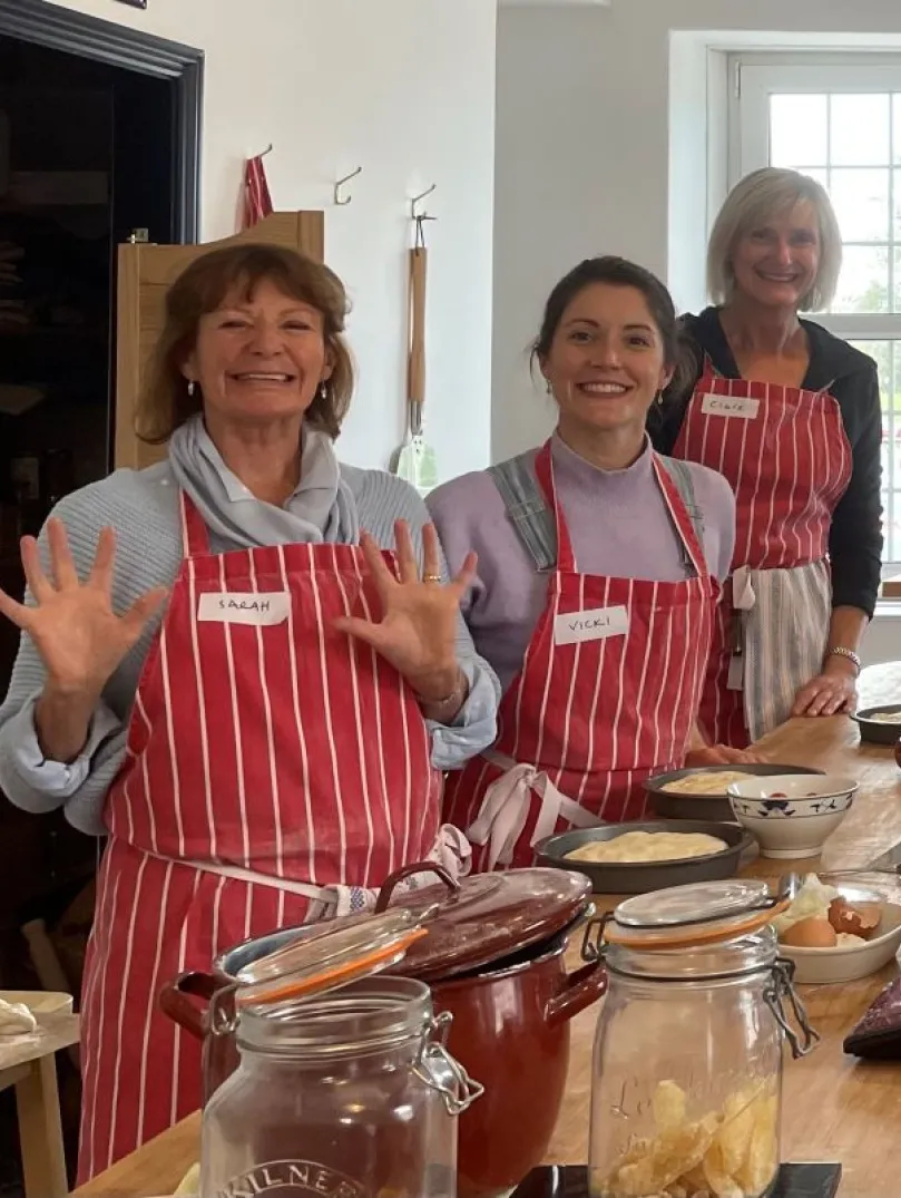 A group of people around a table at a baking class.