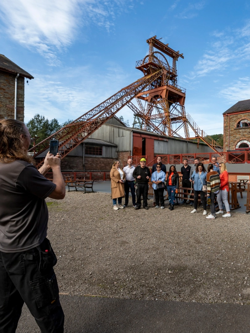 Group posing for a photo outside a coal mining experience.
