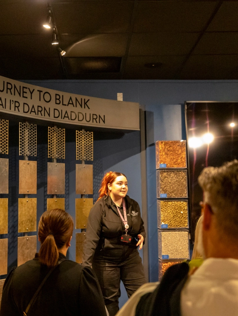 Group of people listening to a tour guide at The Royal Mint.