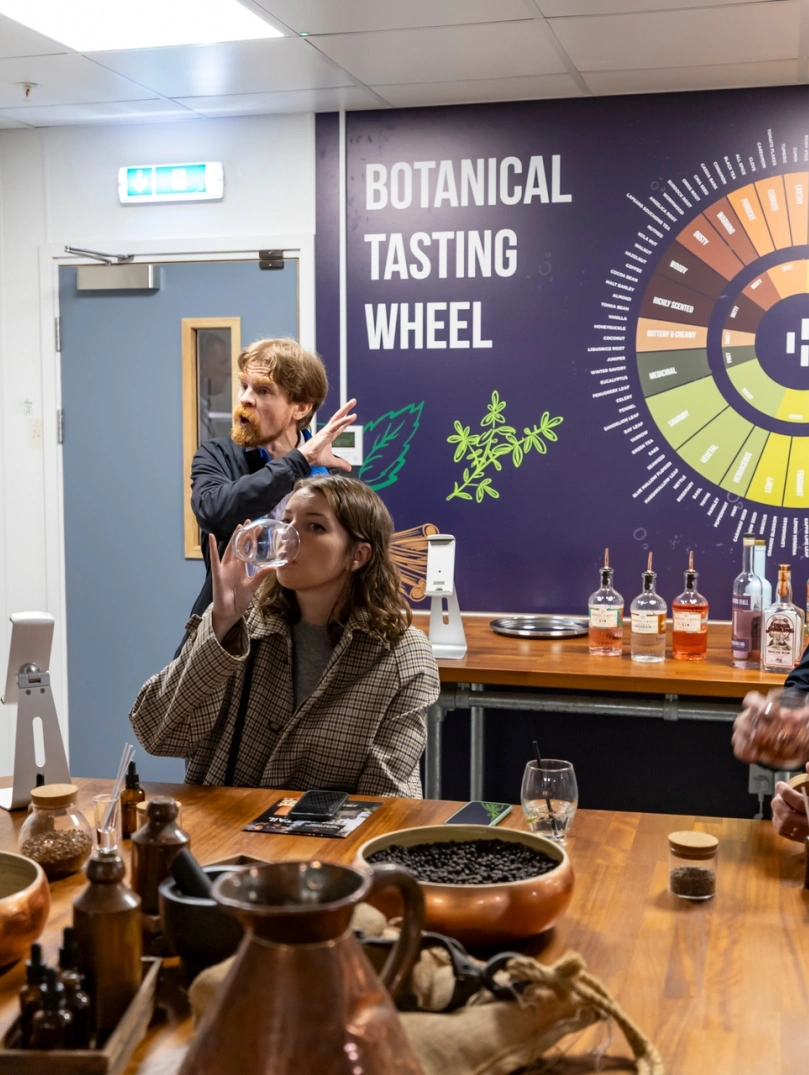 Group of people taste testing on a distillery tour.