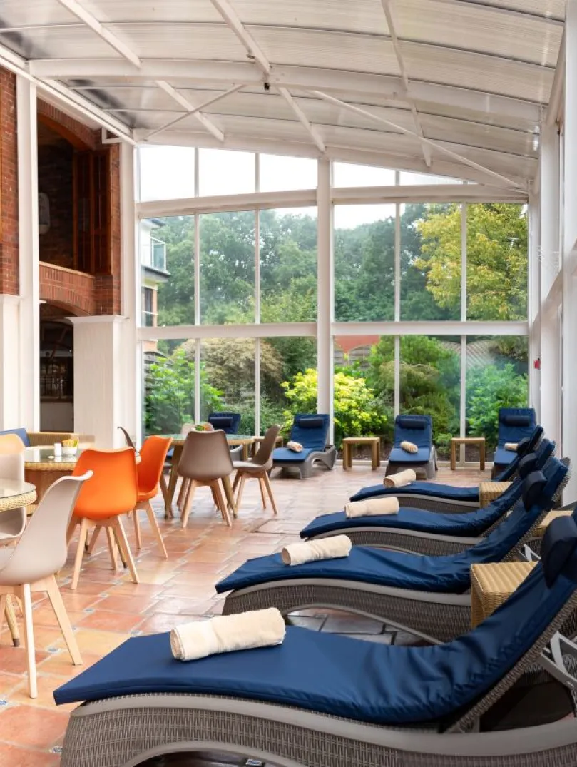A conservatory and outdoor seating in a spa.
