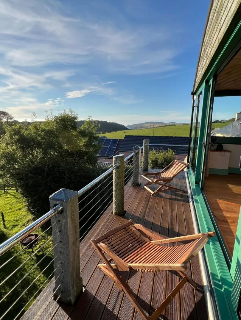 Seating on the balcony of an accommodation with countryside views.