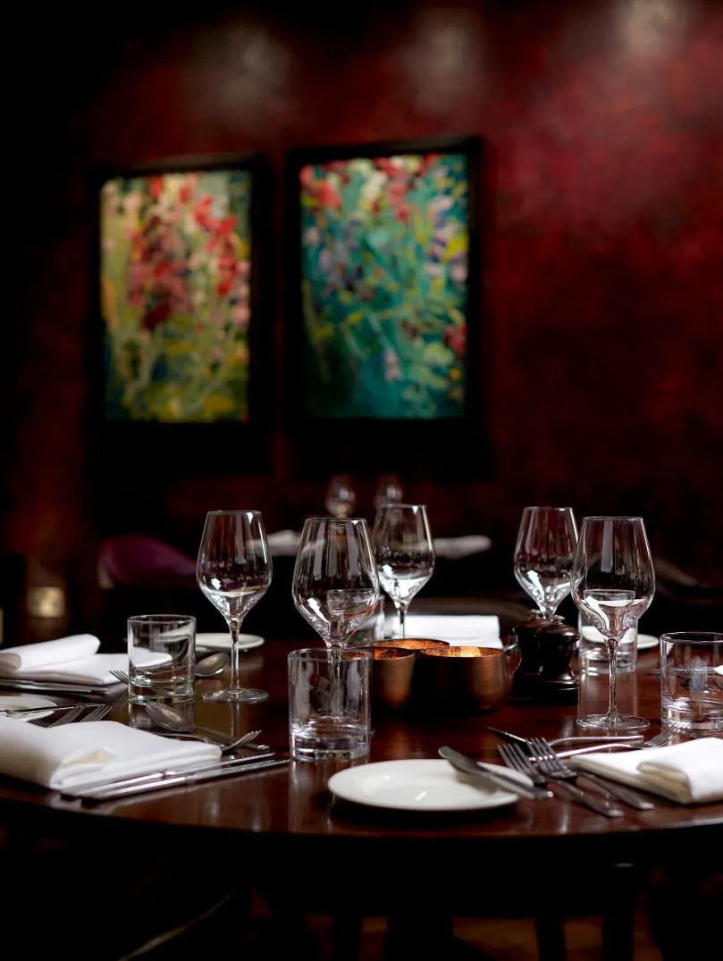 A table set up in a dining room at a hotel.