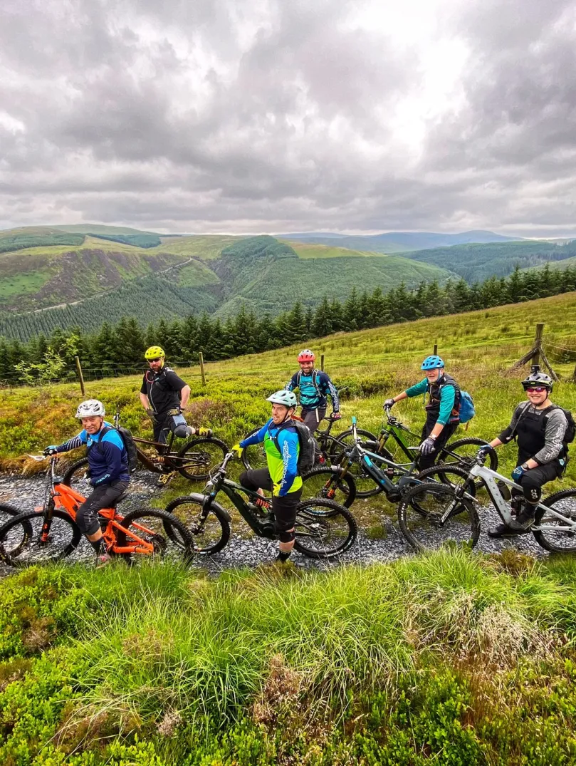 Group of cyclists on eBikes with mountain views beyond