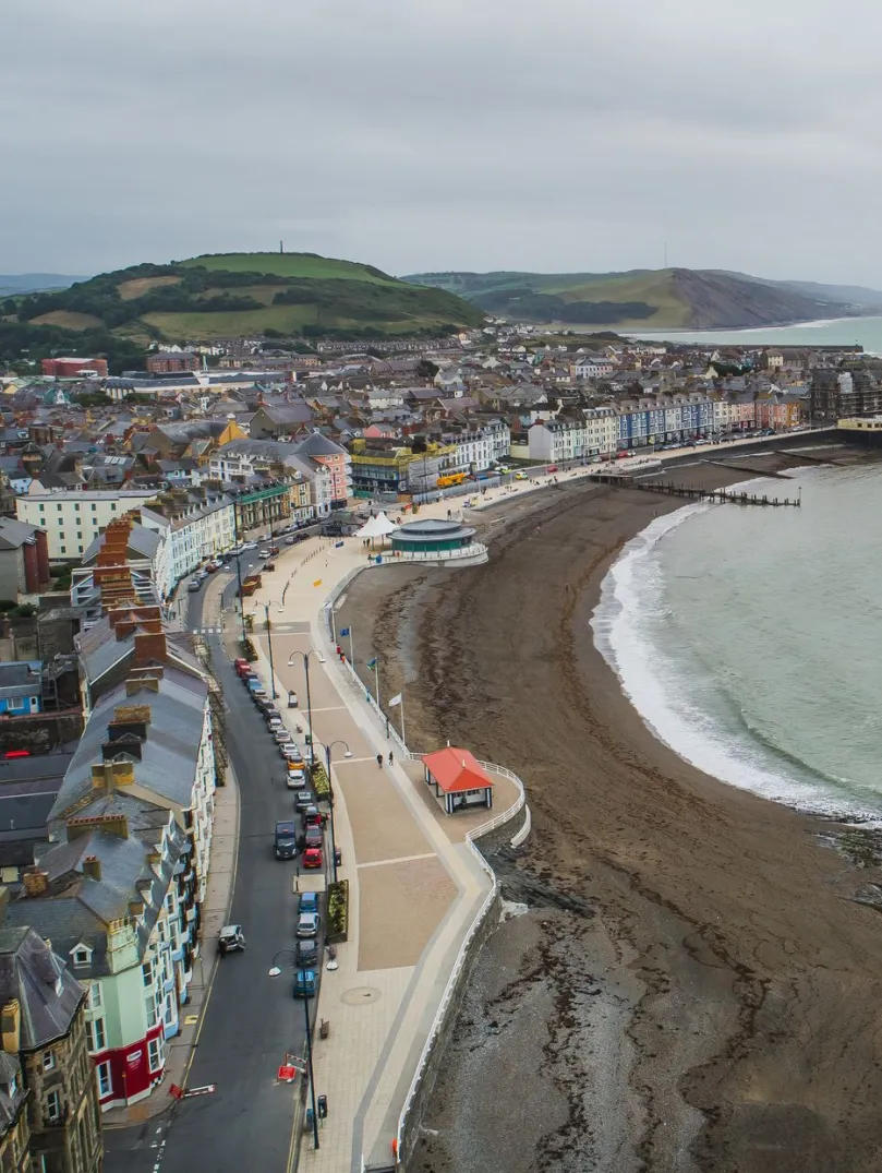 A coastline and town taken from the top of a cliff.