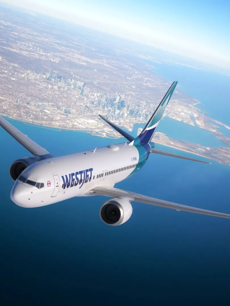 An aircraft in the sky above the sea.