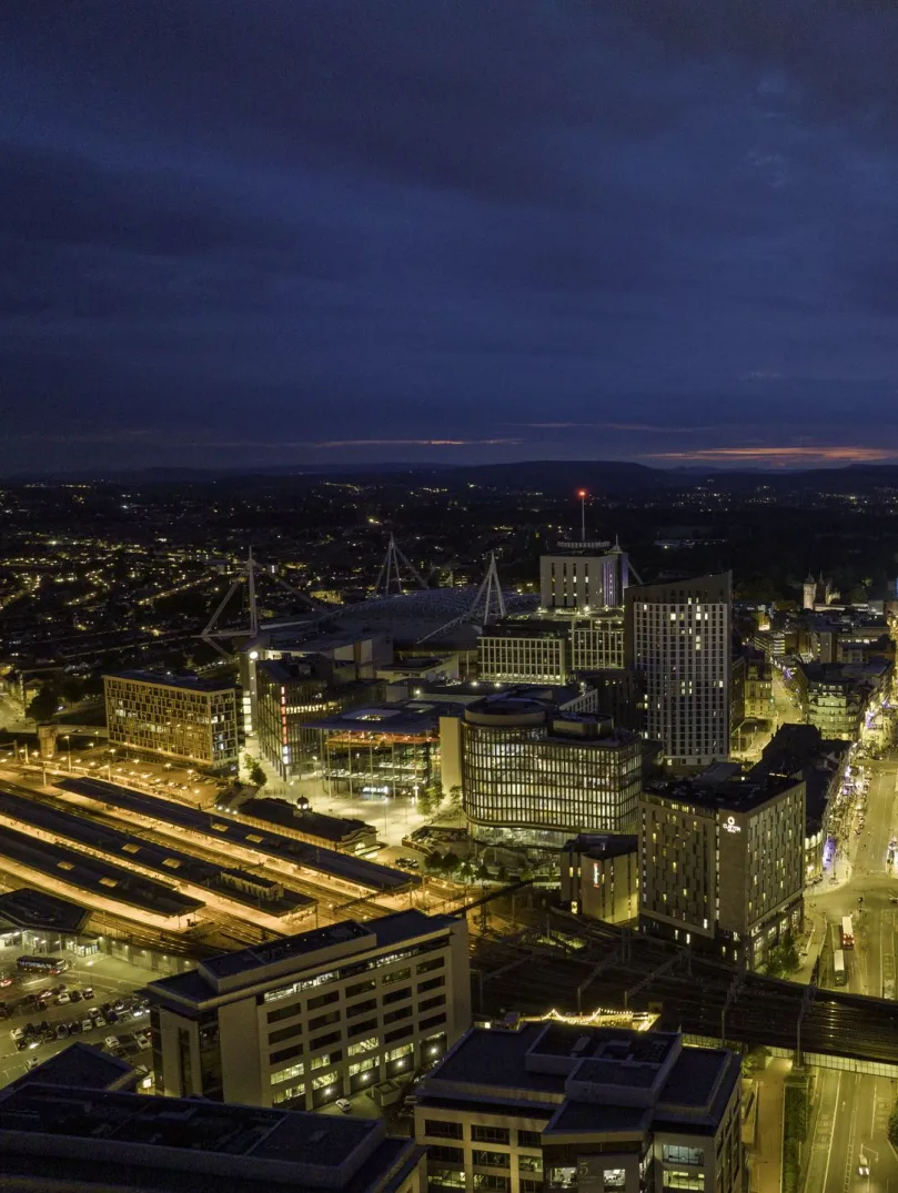 Aerial shot of a city all lit up at night.