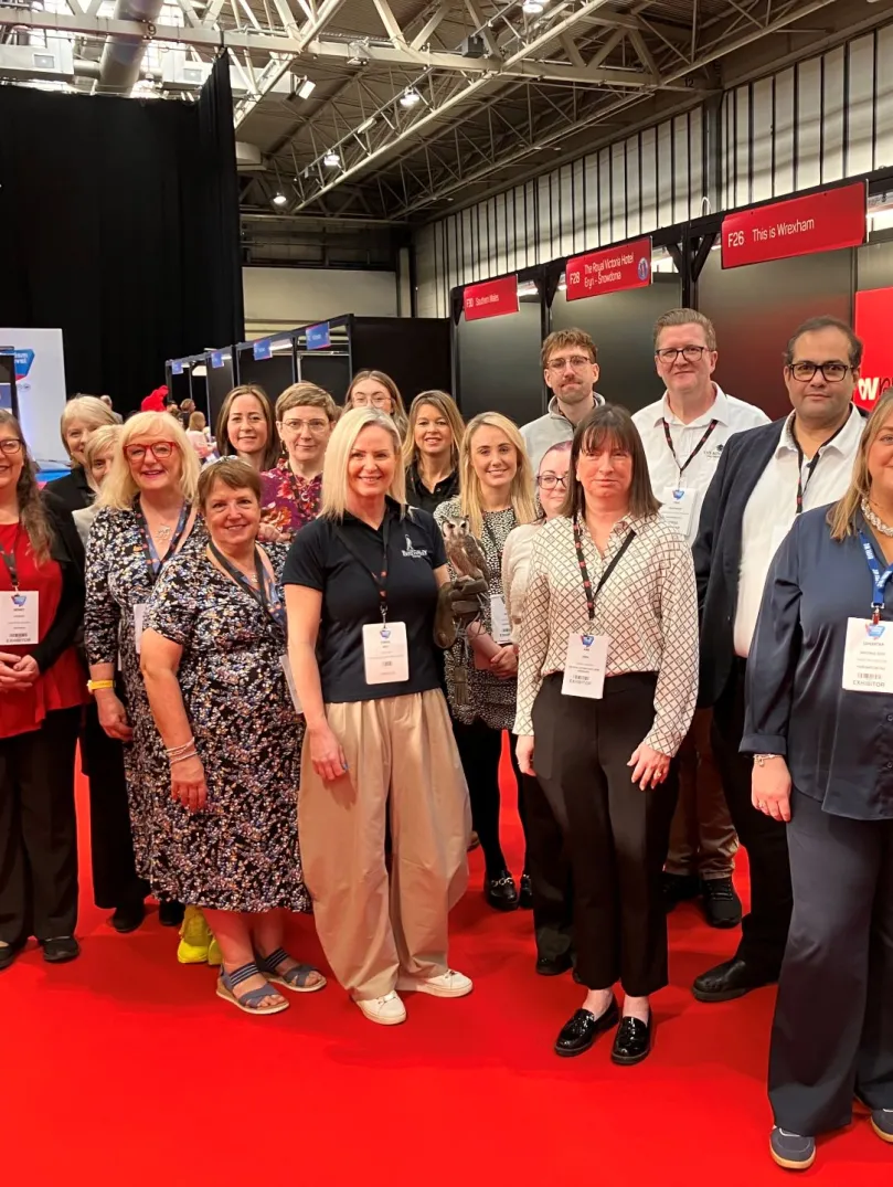 Group of people at a trade show smiling at the camera