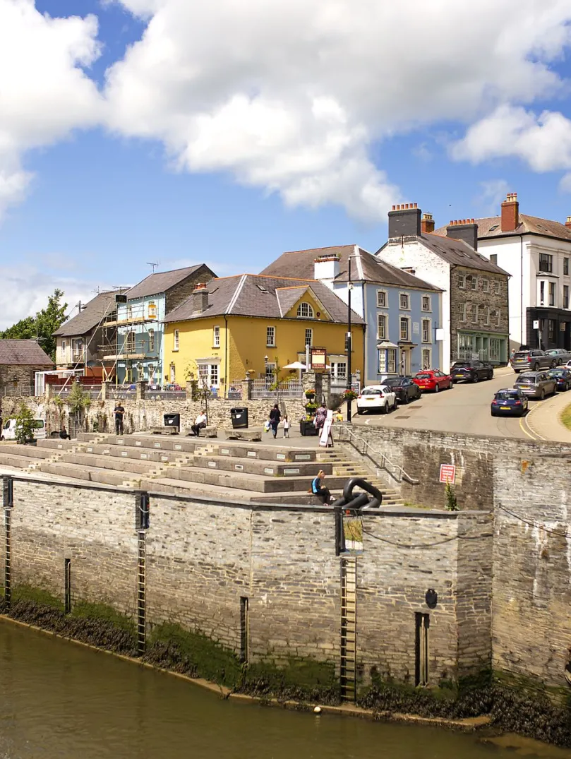 A river with colourful buildings above