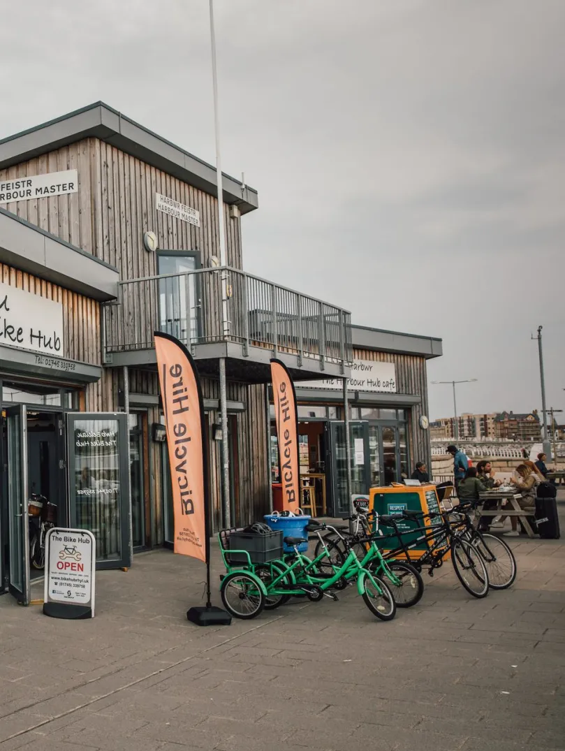A bicycle hire hut with bikes on display outside.