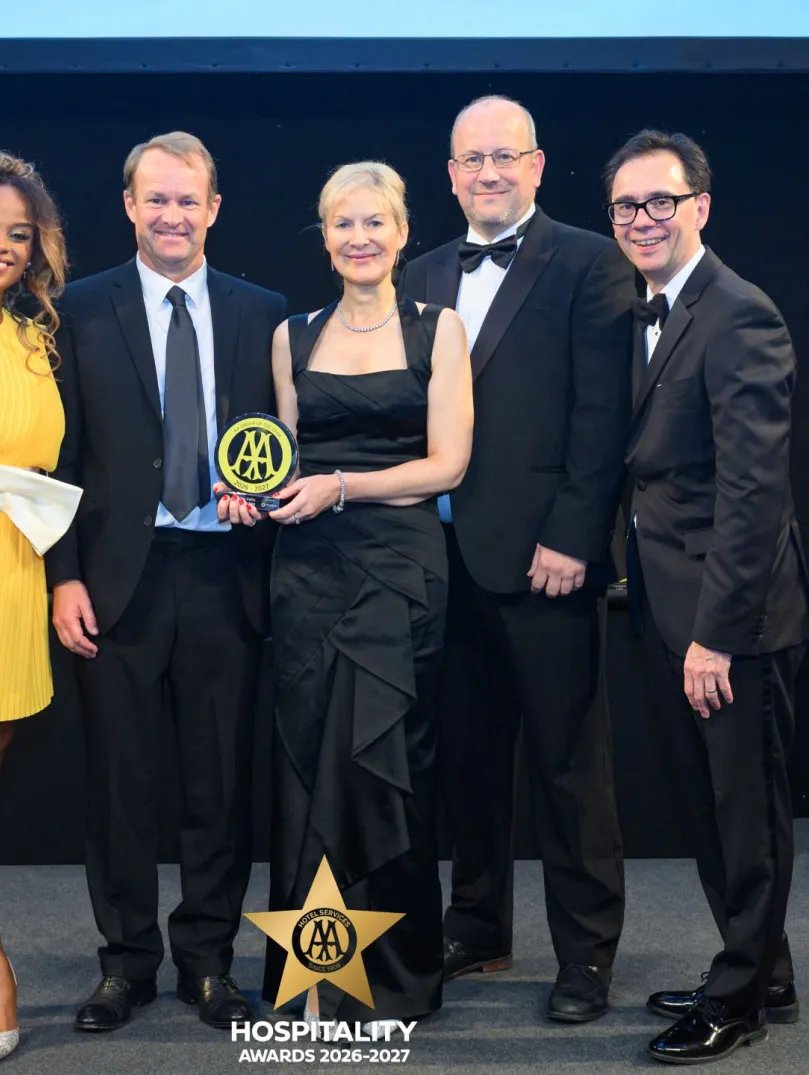 Group of people with an award posing for the camera.