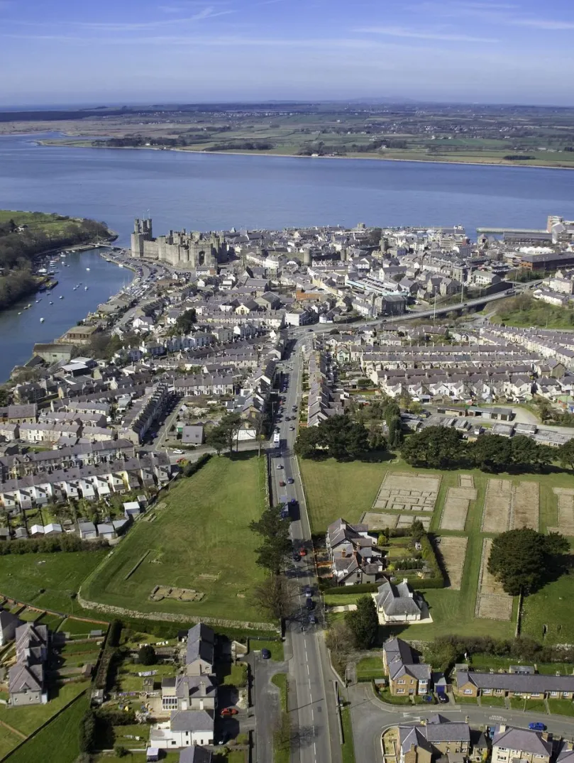 Aerial shot of a town, castle and shoreline.