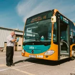 A driver inspecting his bus before heading to Cardiff Bay.