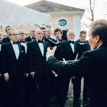 Male voice choir singing and being conducted at Portmeirion.