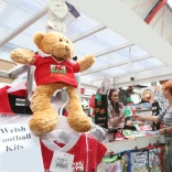 A stall in a market selling Welsh branded souvenirs.