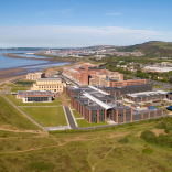 An aerial shot of Swansea University Bay Campus with views across the bay.