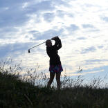 Silouette of a lady golfer taking a swing at Pyle and Kenfig Golf Club.
