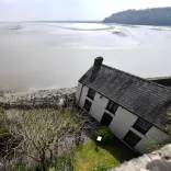 Views of a boathouse and the estuary beyond.