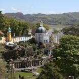 A view of Portmeirion village and gardens beyond the trees.