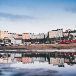 Tenby Harbour at low tide with reflection in water