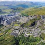 Aerial shot of a village and the slate quarries surrounding it.