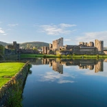 Castle overlooking a moat and greenery
