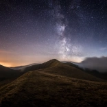 Stars in the night sky with mountains.