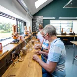 Visitors on a tasting tour at a distillery.