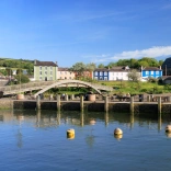 A footbridge going over the estuary in a pretty coastal town.