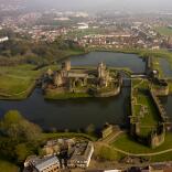 Aerial shot of a castle surrounded by a moat.