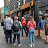 A group of people on a walking food tour in a city.
