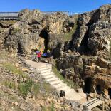 People looking at the rocks near the entrance to an underground mine.