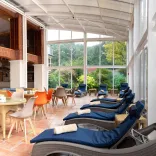 A conservatory and outdoor seating in a spa.