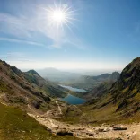 A mountain pass with views of lakes between them.