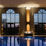 A pool and loungers at a hotel health club.